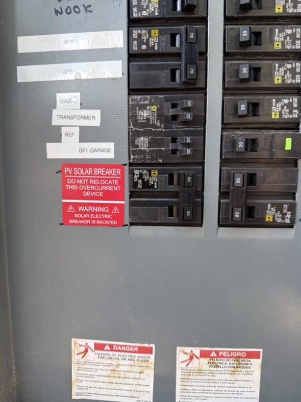 Example main-panel solar breaker and PV warning label